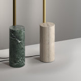 Hilow Line floor lamp base in Alps Green marble with brushed brass rod, shown beside a travertine version on a neutral grey background.