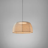 Tanit S/61 fabric LED pendant light with a wide, faceted beige cotton shade on an eight-sided frame, matt black canopy and stem, shown lit against a plain grey background.