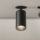 Carl Adjustable Recessed LED Downlight in black, cylindrical head on short stem with round ceiling trim, shown angled with warm white light visible, matt finish.