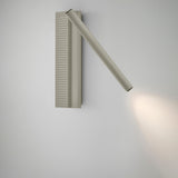 Arid A/03 LED wall light in aluminium with Textured Pebble Grey finish, ribbed rectangular back plate and angled tubular arm casting warm light, shown on a plain white wall.