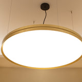 Lite Hole S60 round LED pendant light in gold-finished aluminium with a white diffuser panel, suspended by thin cables from a ceiling canopy.