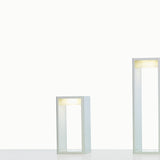 Frame M Glass LED Bollard Lights in white, shown in two heights with open rectangular frames and integrated warm-white LED glowing beneath the top bar, on a plain white background.