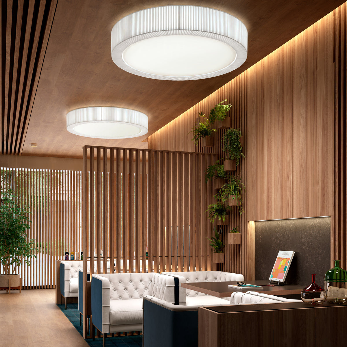 Urban PF/60 Ribbon LED ceiling lights in white, round drum shades with pleated translucent fabric sides, installed flush against wood-panelled ceilings in a lounge setting.