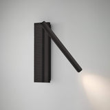 Arid A/03 LED wall light in Textured Black, with a ribbed aluminium back plate and an angled tubular arm directing warm light downward, shown on a plain grey background.