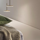 Bella Direct Aluminium LED Pendant Light in Brushed Titanium, two slim round disc fixtures at different heights above a bed with green cushion and knit throw.