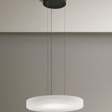 Côte frosted white glass LED pendant light with ribbed underside, suspended from a black ceiling canopy on three thin cables against a neutral wall.