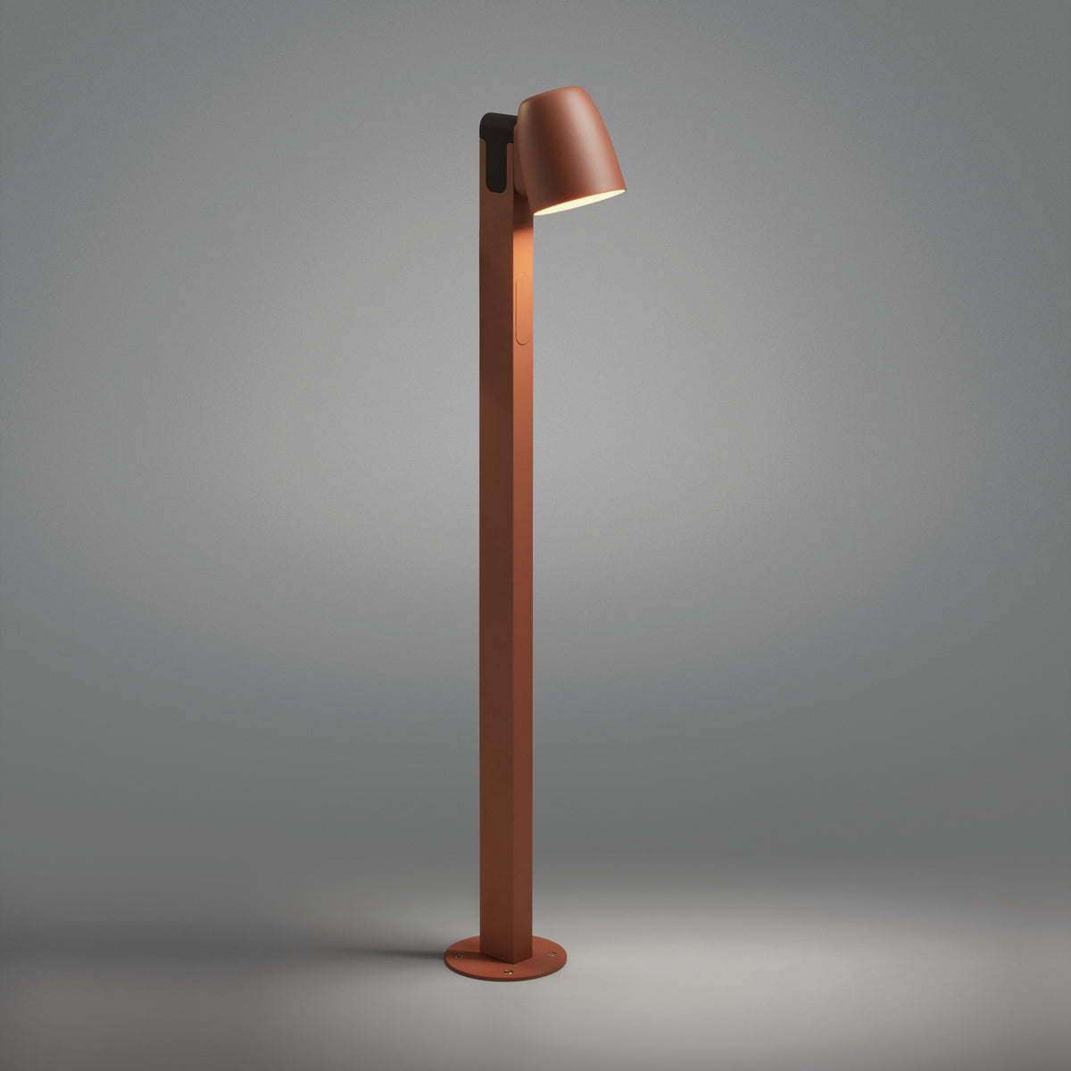 Nut B/90 Bell LED bollard light in textured terracotta, a slim square post with an angled bell-shaped head casting warm light, shown against a plain grey background.