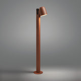 Nut B/90 Bell LED bollard light in textured terracotta, a slim square post with an angled bell-shaped head casting warm light, shown against a plain grey background.