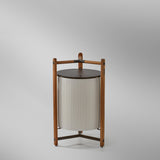 Kando P/76/R rechargeable LED floor lamp with white pleated ribbon shade, round brown top disc, and open three-legged wooden frame on a plain grey background.