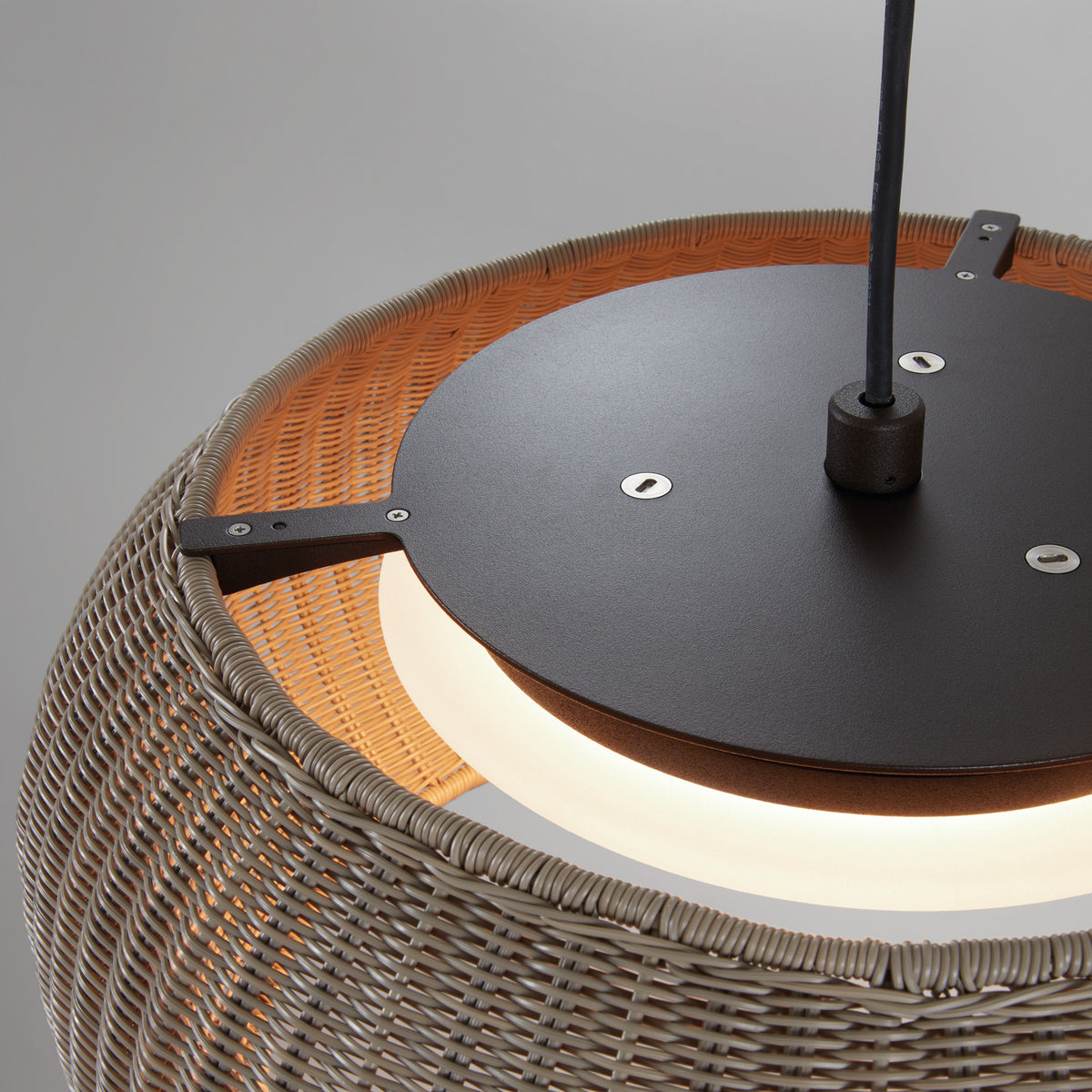 Close-up of the Perris S/47 globe LED outdoor pendant light showing the matte black canopy, hex fittings, black cable, and brown woven shade with integrated LED ring.