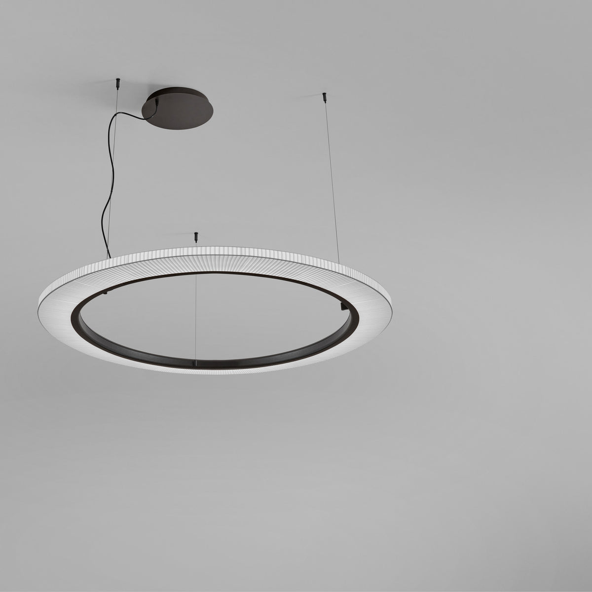 Roda S/120 Ribbon Ring LED pendant light, a large white translucent ribbon-shaded ring with a dark inner band, suspended from a black ceiling mount against a plain grey background.