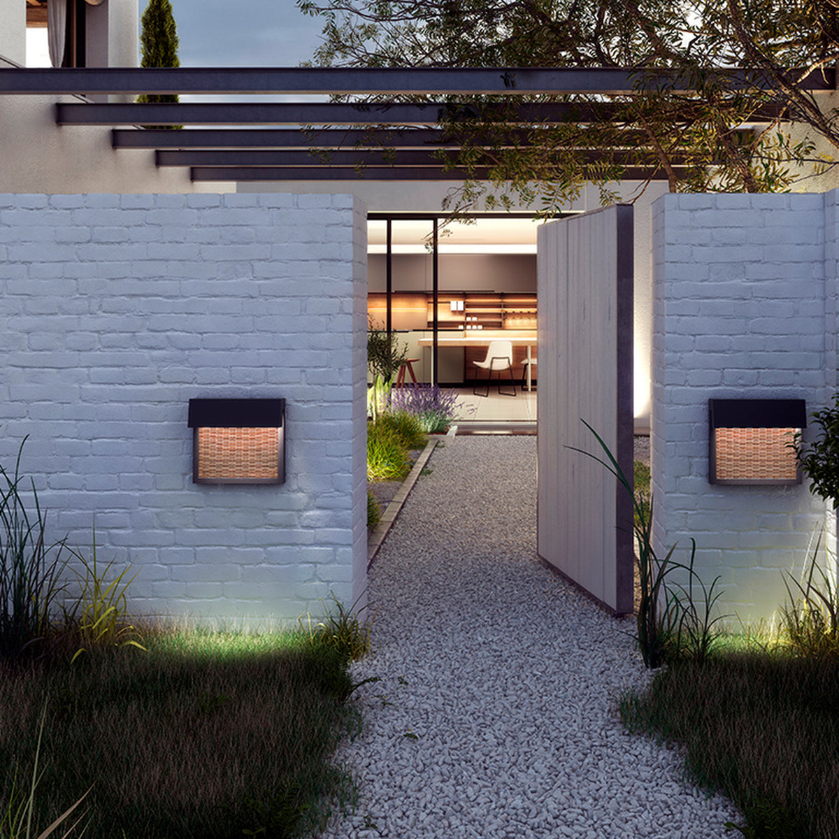 Sisal A/01 LED outdoor wall lights with woven brown fibre front panels and square hooded frames, mounted either side of a garden entrance gate at dusk.