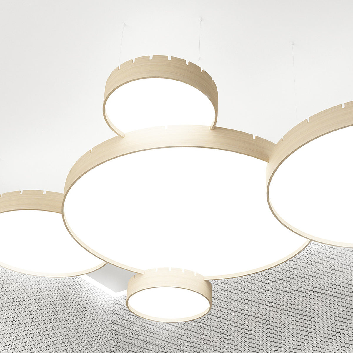 Castle S120 Aluminium LED Pendant Light in wood-tone finish, shown as multiple round drum pendants with notched edges and white diffusers, suspended at varied heights from a white ceiling.