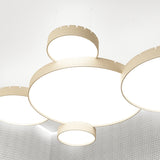 Castle S120 Aluminium LED Pendant Light in wood-tone finish, shown as multiple round drum pendants with notched edges and white diffusers, suspended at varied heights from a white ceiling.