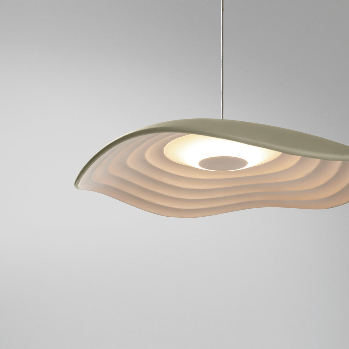 Valentina S/24 LED pendant light with a wave-edged leaf-shaped shade, olive grey on top and white, finely tiered underneath, shown against a plain light grey background.