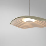 Valentina S/24 LED pendant light with a wave-edged leaf-shaped shade, olive grey on top and white, finely tiered underneath, shown against a plain light grey background.