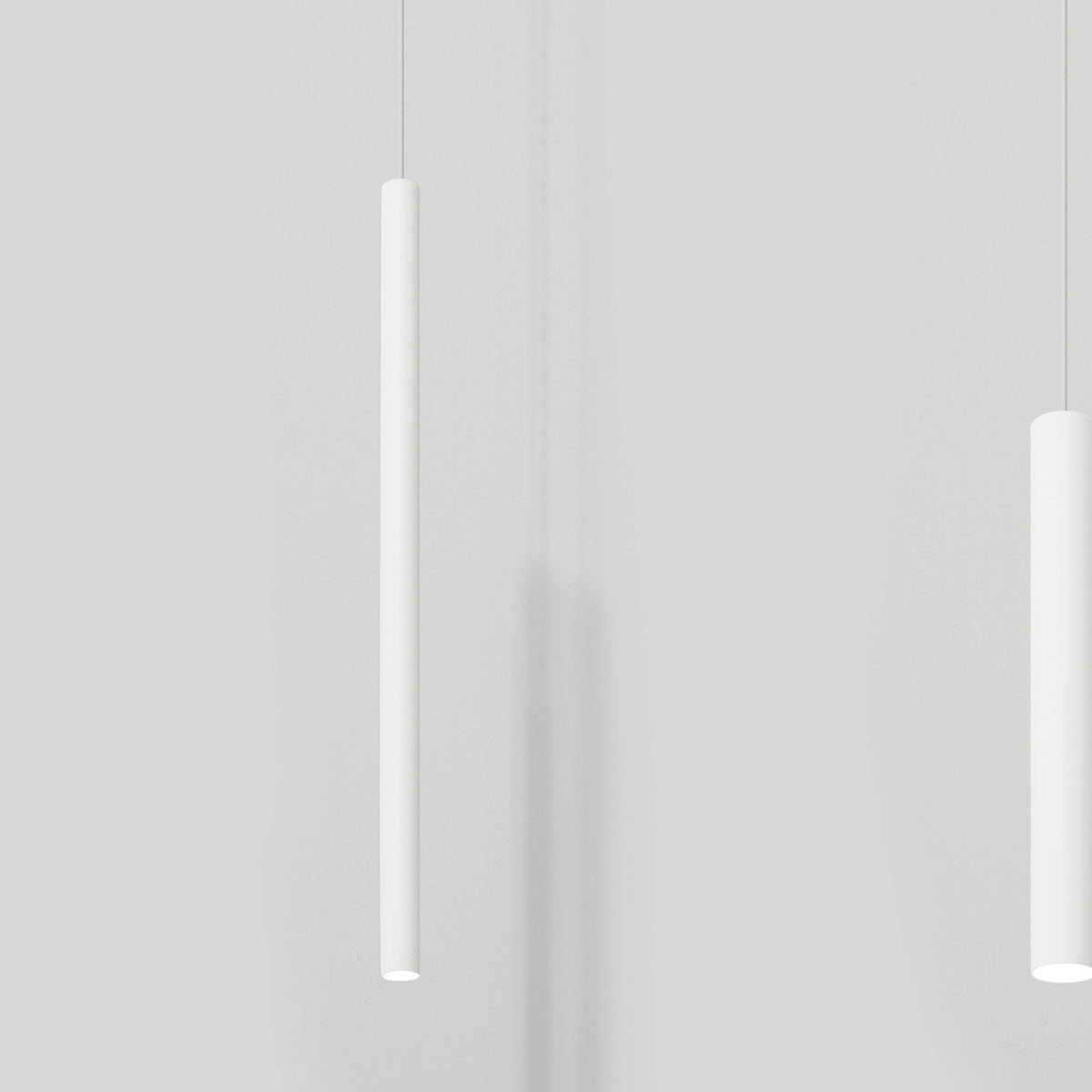 To-Be Aluminium Linear LED Pendant Light in white, slim 65cm tube suspended on a thin cable, shown against a plain light grey wall.