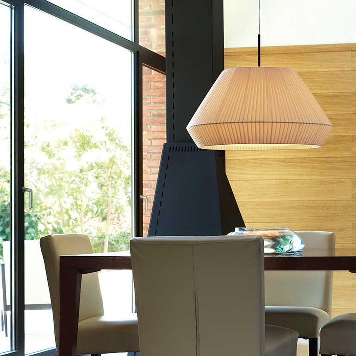Mei 60 Ribbon Cone Pendant Light with a wide, pleated cream fabric shade hanging over a dining table in a modern living space.