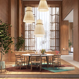 Folie S/70.2 Ribbon Tiered Pendant Light in cream, shown in multiples over a round wooden dining table, its pleated translucent shade glowing with a soft ambient light.