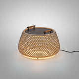 Nans Bag/38 Wood LED outdoor floor lamp with woven brown lattice shade, dark flat top, two teak handles, illuminated against a plain grey background.