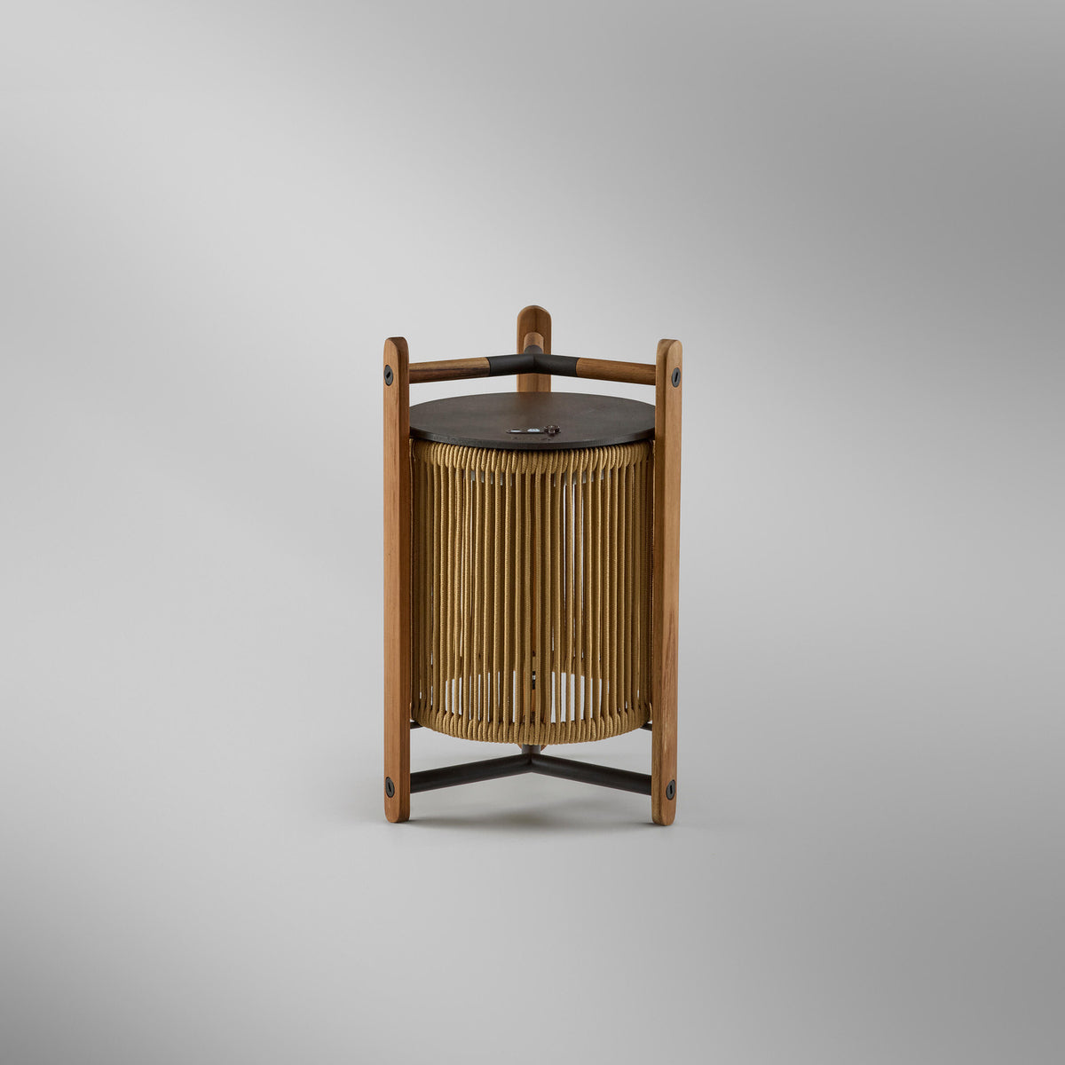 Kando M/40/R rechargeable outdoor table lamp, lantern form with sand nautical cord cylinder, teak wood uprights and dark top and base arms, on a plain light grey background.
