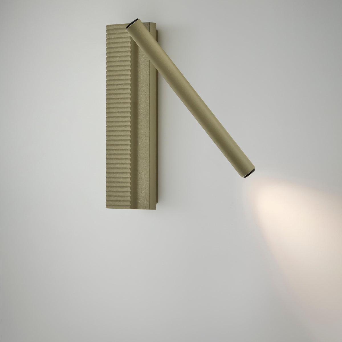 Arid A/03 aluminium LED wall light in textured olive grey, a fluted upright plate with an angled slender tube casting a focused warm white beam, shown on a plain white background.