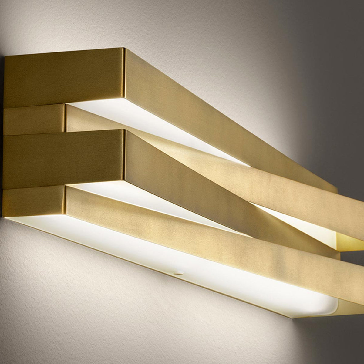 Cross Glass LED Wall Light 30cm in brushed brass finish, crossed bar design with integrated LED strips casting warm light up and down the wall.