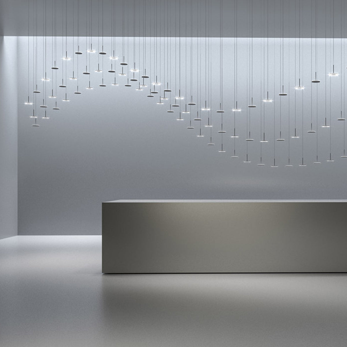 Bella Direct LED pendant lights in Brushed Bronze, multiple slim disc heads on thin stems suspended in a wave arrangement above a reception desk in a modern interior.