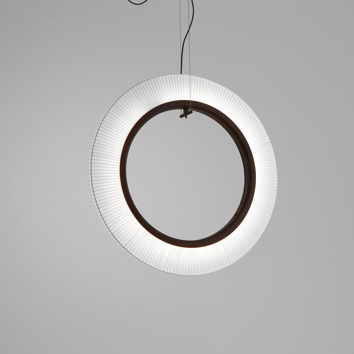 Roda S/90/V Ribbon Ring LED pendant light, a large circular fixture with finely pleated white translucent shade around a dark inner ring, suspended on thin cables against a plain grey background.