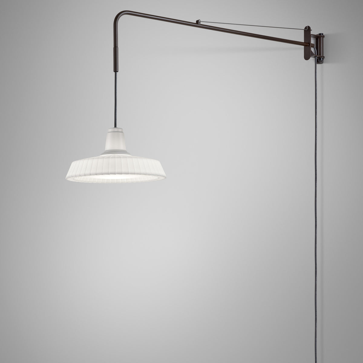Marietta 32 A/98 outdoor wall light with a long bronze arm extending from a wall plate, suspending a pleated white cone shade on a cable, shown against a plain light grey background.