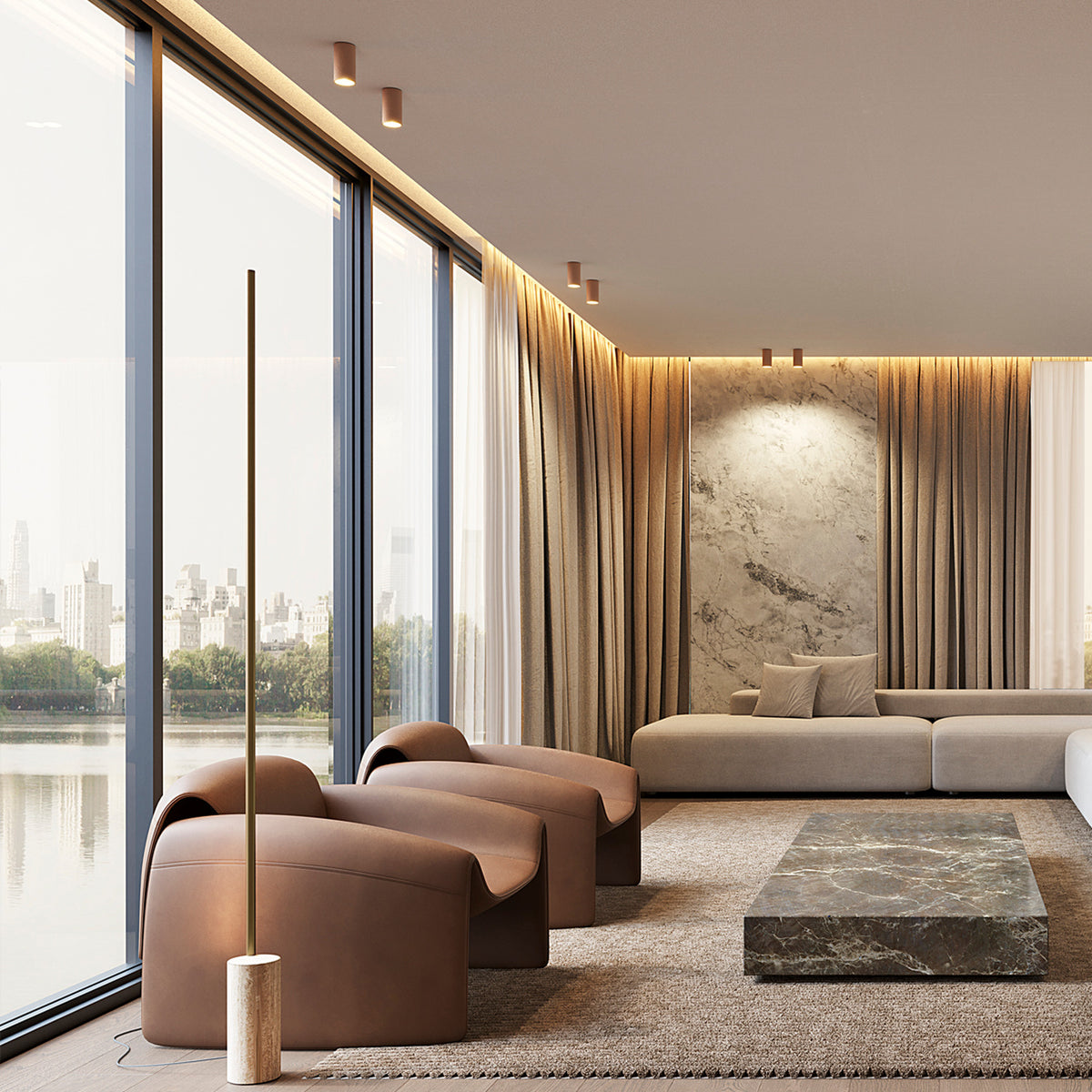 Small cylindrical surface-mounted downlights in brushed bronze, recessed into a ceiling above floor-to-ceiling windows in a modern living room with leather armchairs and a sofa.