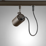 Spotlight Outrack aluminium outdoor track spotlight in brown, cylindrical head mounted on a track with visible power cable, shown against a plain grey background.