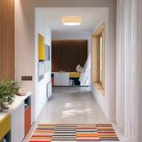 Plafonet 43 Ribbon Drum Ceiling Light in white translucent ribbon shade, flush-mounted on a hallway ceiling above a bright, minimalist corridor.