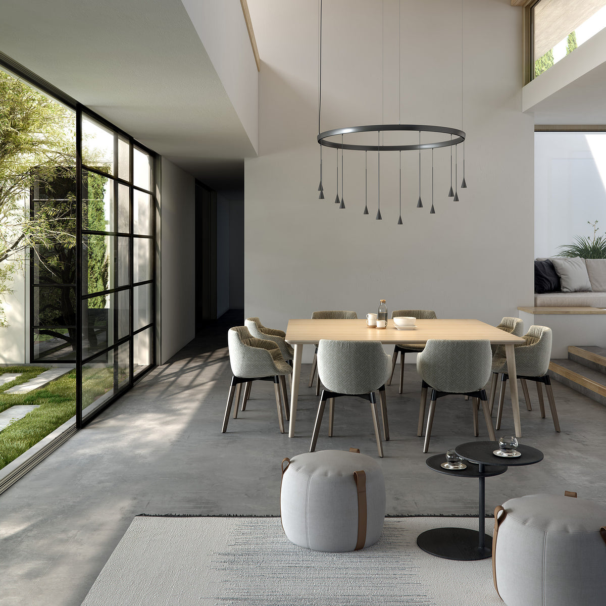 Skybell Circle Iron Ring LED Pendant Light in Ebony Black, a circular ring fixture with cone-shaped heads on slim stems, shown above a dining table in a modern living space.