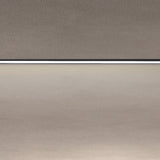 Close-up of the Street Line Linear LED Track Spotlight in black, showing the slim bar's continuous white diffuser strip set between grey ceiling and wall surfaces.