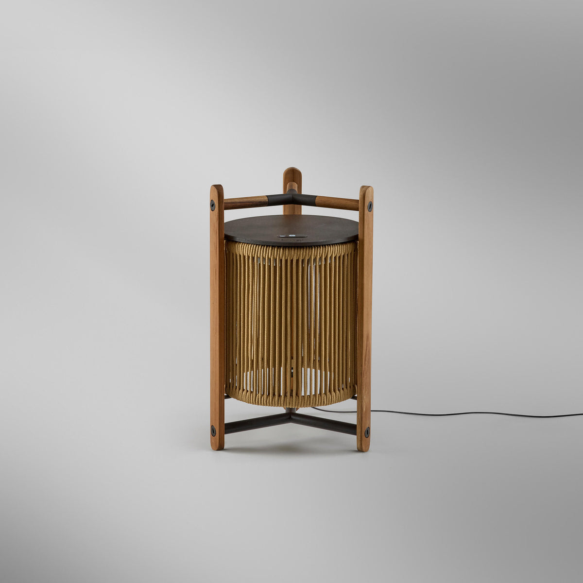Kando M/40 Wood LED Table Lamp in Sand, a lantern-style design with sand-coloured strand shade in a teak wood frame, dark brown top disc, and cross braces, shown on a plain light background.