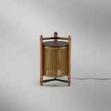 Kando M/40 Wood LED Table Lamp in Sand, a lantern-style design with sand-coloured strand shade in a teak wood frame, dark brown top disc, and cross braces, shown on a plain light background.