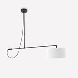 Raisa Fabric Drum Pendant Light in matt black, featuring a slim offset arm from a round ceiling canopy to a white fabric drum shade with a small counterweight, shown on a plain white background.