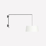 Raisa Fabric Drum Adjustable Swing Arm Wall Light in matt black, with a long iron arm and suspended white fabric drum shade on a textile cable, shown on a plain white background.