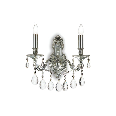 The Sonnet 2 Light Crystal Wall Light in chrome features two candle-like light bulbs, intricate ornate detailing, and draped crystal pendants, offering an elegant lighting fixture that seamlessly combines classic charm with sophisticated design.