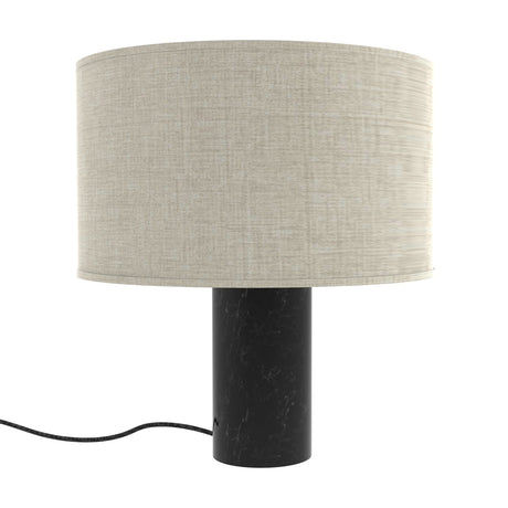Romy Drum Table Lamp with a wide beige cotton drum shade on a cylindrical black marble base with pale veining, shown on a plain white background.