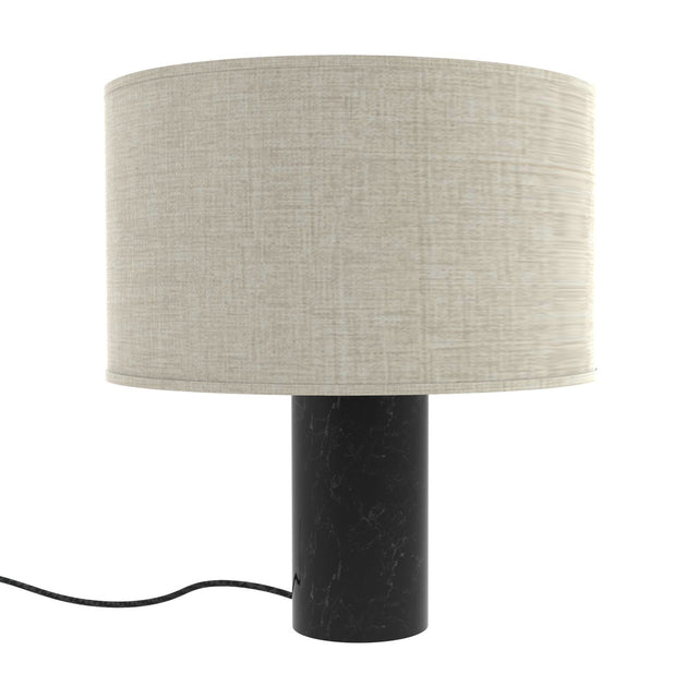 Romy Drum Table Lamp with a wide beige cotton drum shade on a cylindrical black marble base with pale veining, shown on a plain white background.
