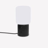 Remi Lantern Table Lamp with a rounded square opal glass shade on a cylindrical black marble base with pale veining, shown with cable on a plain white background.