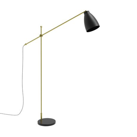 Nala adjustable floor lamp with matt black dome shade, gold pivoting arm, slim upright stem and round black marble base, shown on a plain white background.