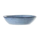 Sandrine Stoneware Deep Plate in blue, oval ceramic shape with speckled glaze and dark rimline, shown side-on against a plain white background.