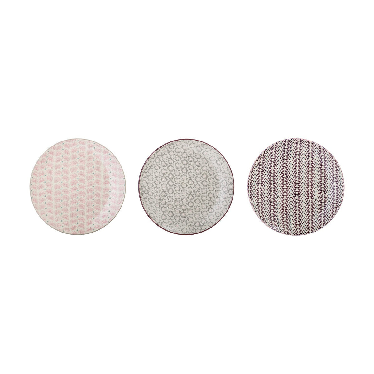 Maya Side Plate in three assorted designs on a plain white background: pink fan-like floral pattern, grey scattered floral pattern, and burgundy chevron pattern on round stoneware plates.