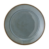 Pixie Stoneware Dinner Plate in blue, round with a wide flat rim and sunken centre, reactive glaze with brown edge detailing, shown on a plain white background.