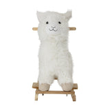 Kinto Rocking Llama in white, a shaggy plush toy on wooden rockers with a through-head handle grip, stitched face and poplar wood base, shown on a plain white background.