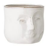 Ignacia Stoneware Plant Pot in white with a sculpted face in relief, closed eyes and full lips, rounded ceramic form on a plain background.