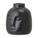 Eliot Stoneware Candle Holder in black, a face-shaped ceramic vase-style holder with raised eyes, nose and smile, textured glossy finish, on a plain white background.